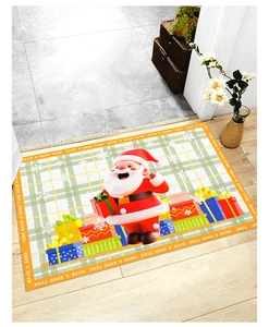 Detailed Christmas mat showing 3D Santa and gift box pattern on green plaid base