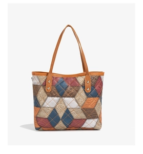Close-up of color-block tote bag featuring crocodile embossed texture and rhombus pattern