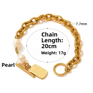 Detail of gold chain bracelet with OT buckle, baroque pearls and Soulmate engraved plate