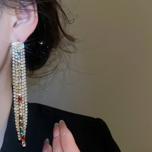 Detailed close-up of colorful rhinestone tassel earrings in vintage gold style