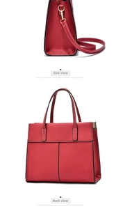 Detail view of red leather handbag with white stitching and luxury gold-tone hardware