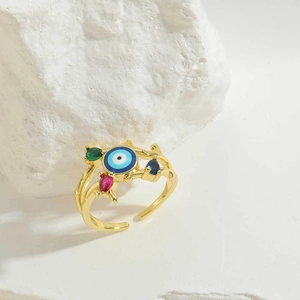 Detail of vintage evil eye ring with colorful pear-cut gems on textured gold band