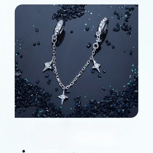 Detailed view of silver star safety chain with sparkling zircons on starry background