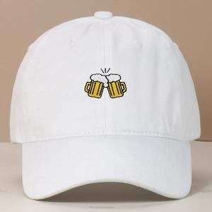 Detail of beer mugs embroidery on the front of a white washed cotton baseball cap