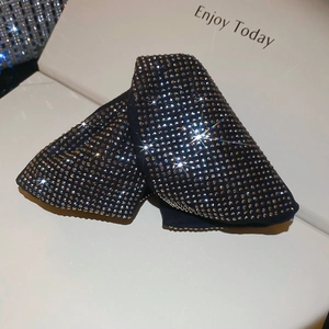 Detail view of premium dark fabric triangle hair claw clip with rows of sparkling rhinestones