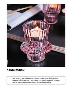 Detail of pink ribbed glass candlestick with elegant wavy base and warm tea light candle