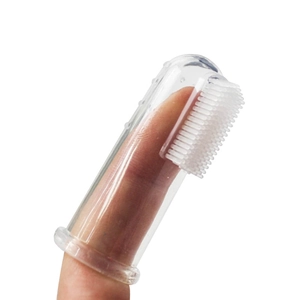 Silicone pet finger toothbrush for dogs and cats with soft bristles on white background