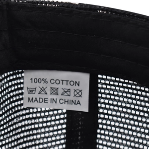 Macro view of inner sewing lines and 100% cotton wash label on the black trucker hat