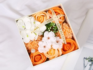 Top view of square gift box with orange soap flowers, pearls and Eternal Love ribbon