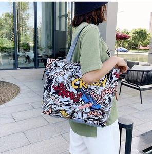 Detail of canvas tote bag featuring vibrant American comic style pop art prints