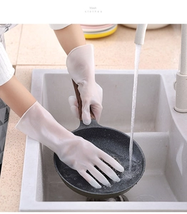 Detailed shot of durable cleaning glove scrubbing non-stick pan with water