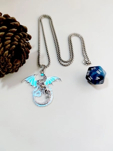 Close-up of a silver dragon necklace with blue luminous wings and a blue d20 die