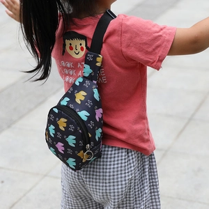 Detailed view of kids nylon chest bag with colorful bird print and adjustable strap