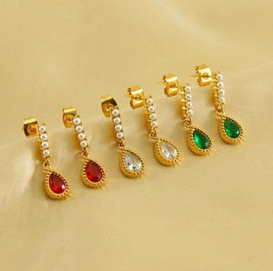 Detailed view of teardrop earrings with gold plating and colorful zircon gemstones