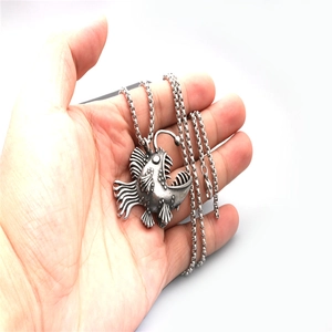 Vintage stainless steel anglerfish pendant necklace shown on hand with detailed silver finish