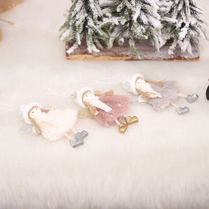Three plush Christmas angel hanging dolls in pink, white and gray on white faux fur