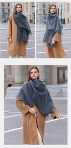 Three-way urban street view showing a woman wearing a dark grey tassel scarf wrap