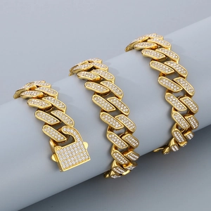 Macro shot of three gold-plated iced out Cuban link chains with shimmering crystals