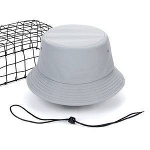 Detail view of grey quick-dry bucket hat with adjustable black windproof chin strap