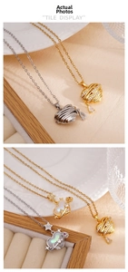 Detail of 18K gold plated heart pendants with zircon accents and mother of pearl inlay