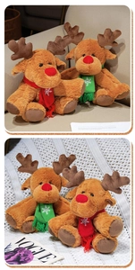 Detail of Christmas reindeer plush toys with snowflake scarves and red noses in a cozy setting