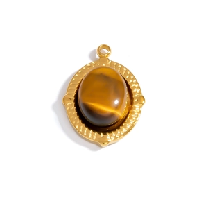 Macro view of gold hammered oval pendant with natural brown cat eye gemstone