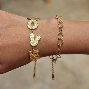 Gold-plated stainless steel LOVE letter and heart link bracelet set on model's wrist