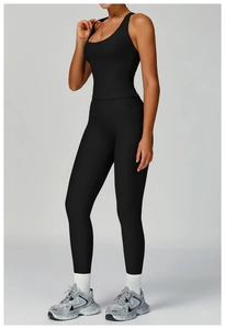 Detail of black ribbed yoga set featuring high-waisted leggings and a tight U-neck vest