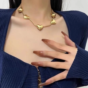 Elegant gold heart pendant necklace featuring five 3D hearts on a chic snake chain