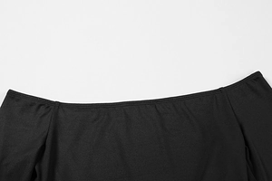 Detailed close-up of high-quality stitching on black strapless dress with smooth fabric