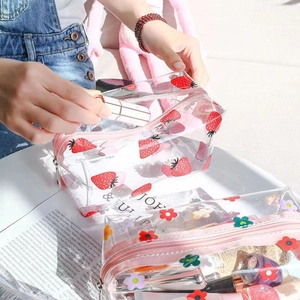 Transparent PVC makeup bag with cute strawberry floral prints and pink zipper closure