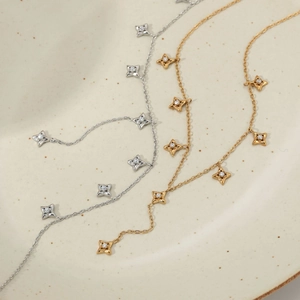 Y-shaped stainless steel necklace set with sparkling star pendants in gold and silver