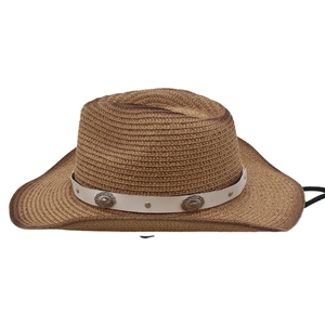 Detail of brown woven straw cowboy hat with white band and retro concho studs
