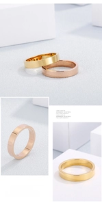 Macro view of wide gold and rose gold rings with brushed finish and polished inner bands