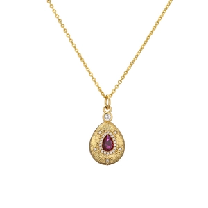 Golden teardrop pendant necklace with a red ruby and star pattern on a white background