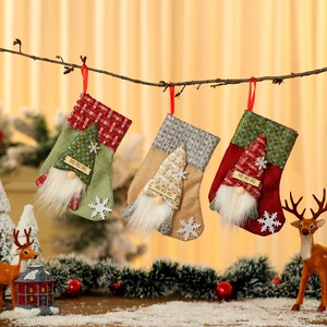 Set of 3 rustic burlap Christmas stockings featuring Santa gnomes and snowflake patterns