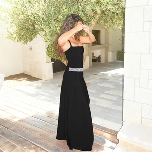Detail of silver rhinestone waist decoration on long black backless dress