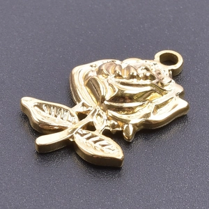 Detailed close-up of a golden rose-shaped stainless steel pendant with stem and leaf