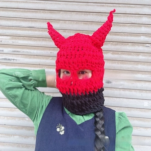 Detail showing red and black hand-knitted devil horn balaclava mask for Halloween costume
