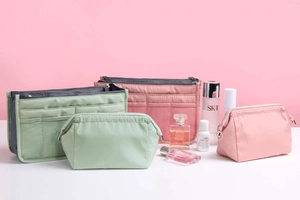Waterproof nylon cosmetic bag set with four assorted pouches in pink and green