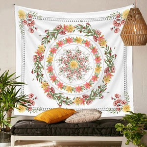 Detailed view of bohemian floral mandala tapestry hanging above a black sofa with cushions