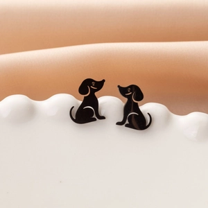 Close-up of black dachshund stud earrings in 304 stainless steel on a white tray