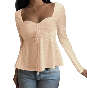 Detailed view of the eyelet lace fabric and drawstring front on the apricot top