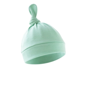Close-up of a soft mint green newborn knotted hat with a folded brim on white background