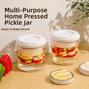 Close-up of airtight pickling jar with manual press lid on a wooden kitchen table