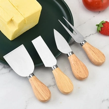 Macro view of four-piece stainless steel cheese knife set with smooth wooden handles