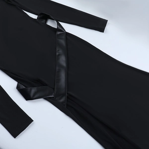 Détail de robe noire à manches longues avec taille lacée en cuir et texture en tricot