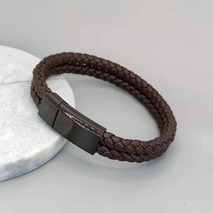 Macro view of double-layer braided brown leather bracelet with black magnetic clasp
