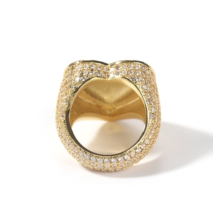 Hip hop heart ring in copper with paved 3A zircons in a shiny gold finish on white background