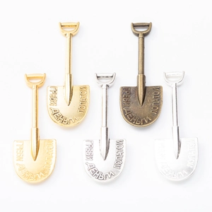 Retro shovel pendant charms in various metal finishes with Russian engraving on white base